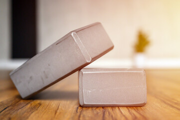 gray support cubes for sports yoga or stretching on the wooden floor on yoga studio or home room. flare