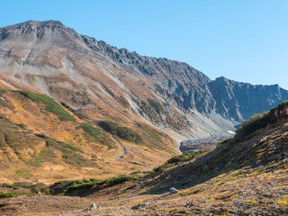 Obraz premium View of the volcano crater Vachkazhets mountain range. The remains of a large volcano crater attracts tourists with its unusual beauty. Kamchatka Peninsula, Russia.