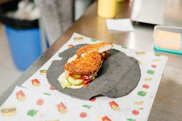Cooking rolls with chicken on a black flatbread