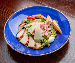 Chicken Caesar Salad. Caesar Salad with grilled chicken on plate. Grilled chicken breasts and fresh salad in plate