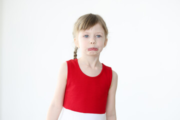 Portrait of little offended girl on white background