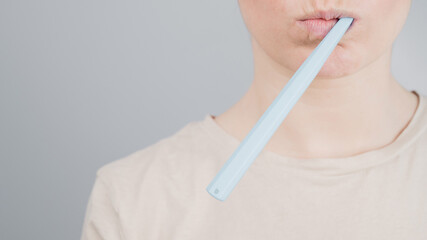 Close-up portrait of caucasian woman brushing her teeth. The girl performs the morning oral hygiene procedure