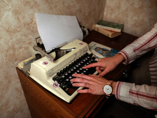 person typing on an typewriter