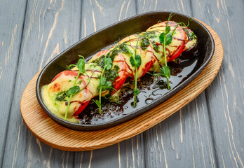 Grilled caprese chicken with mozzarella cheese basil and tomatoes