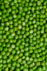 Green peas close up. Green peas texture. Healthy eating seeds of green vegetable pod. Full frame of green peas.