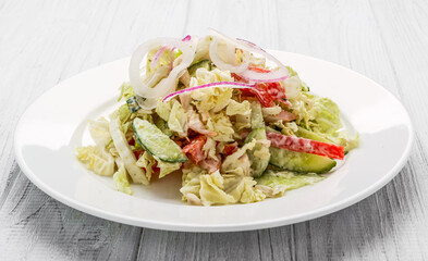 Salad from smoked sausage, spicy carrot, tomato, cucumber and spices, dressed with mayonnaise