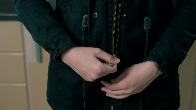 Girl unzips and zips the jacket.