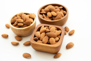 Bowl with almond on on white background. Top view. Flat lay (selective focus; close-up shot).