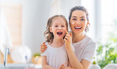 Mother and daughter caring for skin