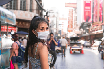 Asian adult woman tan skin wear mask on face for new normal lifestyle.
