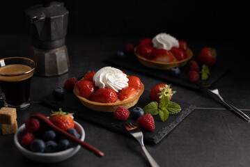 Homemade dessert strawberry pie with raspberry's and blue berry's and a coffee.