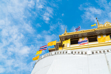 Golden mountain or Wat sraket with blue sky and white cloud background. This is landmark in...