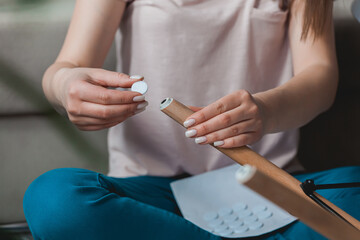 Woman attach felt pad on chair leg, care of floor