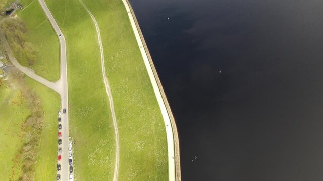 People Walking At Dovestone Reservoir Plug Hole Aerial Drone Fly Over Peak District National Park Greenfield Saddleworth Moor Manchester