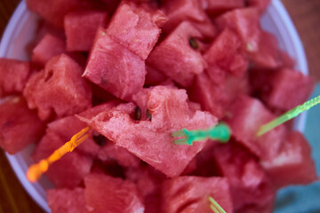 Summer dessert concept. Top view of juicy sweet watermelon cubes on a plate. Summer refreshing and vitaminized raw vegan food. High quality photo
