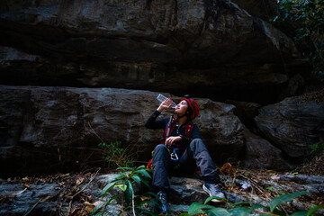 Beautiful young Asian climbers are climbing the high cliffs of northern Thailand.