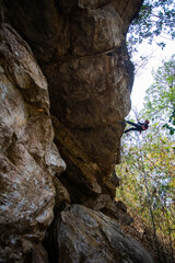 Beautiful young Asian climbers are climbing the high cliffs of northern Thailand.