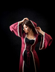 Girl in a medieval dress with a hood. Historical costume. © baxys