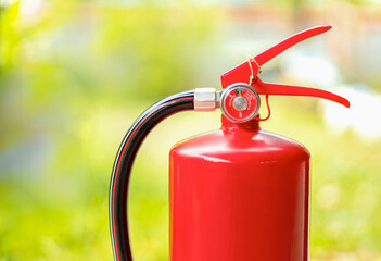 fire safety extinguishers, On a natural green blurred background.