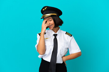 Young airplane pilot over isolated blue background laughing