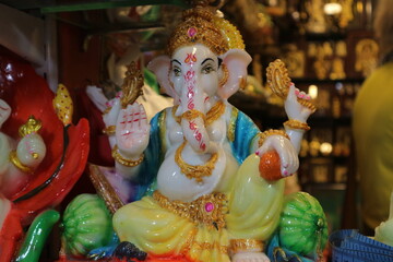 Figurine of God Ganesha. Indian souvenir. Beautiful Ganapati with four arms blesses with a gesture...