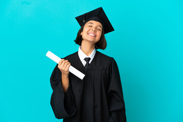 Young university graduate girl over isolated blue background laughing
