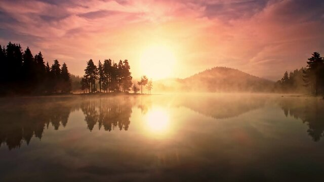 Morning fog on the mountain lake, sunrise view, 4k aerial video