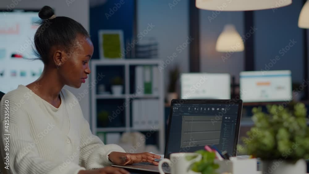Poster black woman engineer designer looking at laptop analysing project using new software to design 3d co