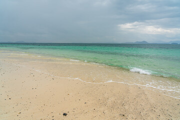 Fototapeta premium White sand beach in khang khao island, Ranong, Thailand in cloudy day.