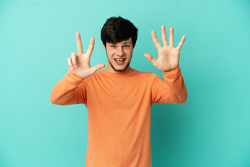 Fototapeta premium Young Russian man isolated on blue background counting eight with fingers