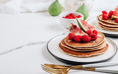 Homemade classic american pancakes with almond, fresh raspberries and figs