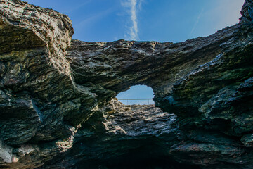 Vendée, France; March 28, 2021: Photo of Trou du Diable seen from the cave, a sea cave on the Corniche de Rié, in the town of Saint-Hilaire-de-Riez. 