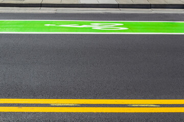 Bicycle path, colorful road markings on the asphalt, bright green color.