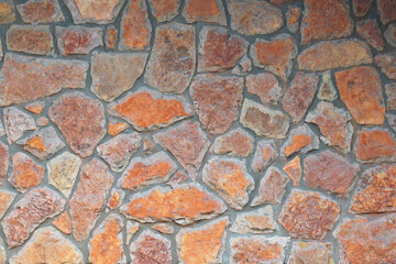  Masonry from natural stones of irregular shape, fastened with mortar. Texture for background.