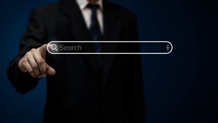 A man is using his finger to touch the search button to browse the internet with a digital touch...