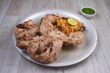 Malai Tandoori chicken is chicken dish prepared by roasting chicken marinated in yoghurt and spices in a tandoor, a cylindrical clay oven. It is a popular dish from the Indian.