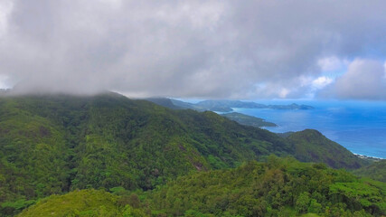 Obraz na płótnie Canvas Mahe', Seychelles. Aerial view of mountains and coastline on a foggy day
