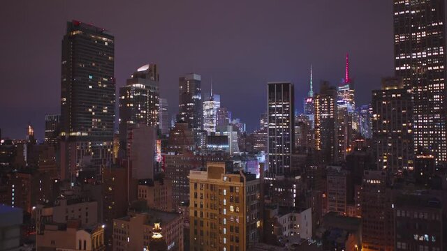 NYC: - Midtown roofs at night with a view of the lights of Times Square, the spires of the HM Tower and One Bryant Park -  New York City, USA