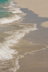 paradise coast waves at a sand beach with turquoise water