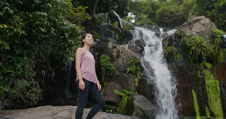 Sport woman look at the waterfall