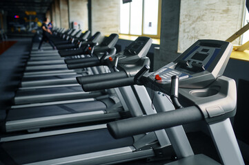 Fototapeta na wymiar Row of treadmills in gym, running machine