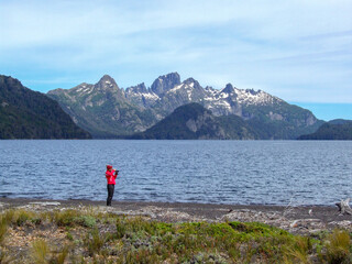 Fototapeta na wymiar woman taking pictures at lago Tromen lake, Lanin national park, Argentina