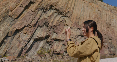Woman take photo on cellphone in Geopark