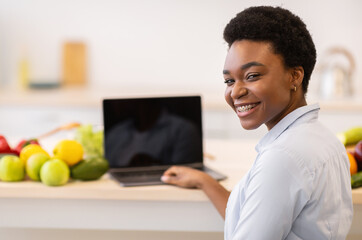 Black Lady At Laptop Posing Sitting In Modern Kitchen Indoor