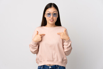 Young Chinese girl over isolated white background with surprise facial expression