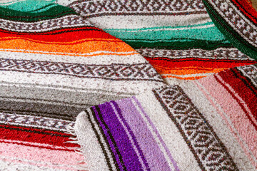 A colorful Southwestern design blanket in striped pattern