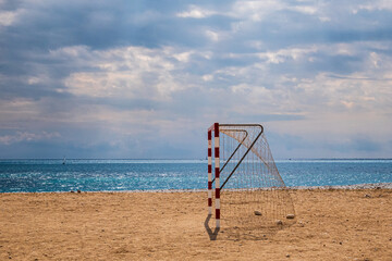 Soccer goal, on a lonely beach with the Mediterranean sea and a cloudy sky.