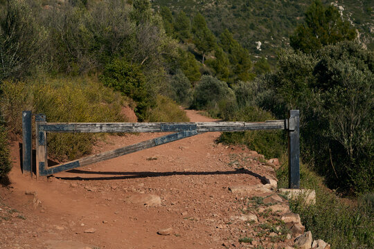 Mountain road cut by a fence