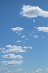 Small cumulus clouds against the blue sky. Background.