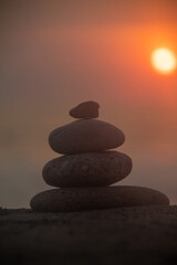 A pillar of rocks with a sunset taking place in the background